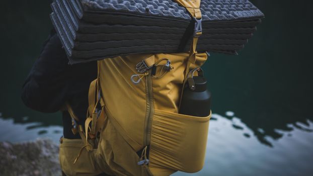 Water bottle packed in the side pocket of a travel backpack