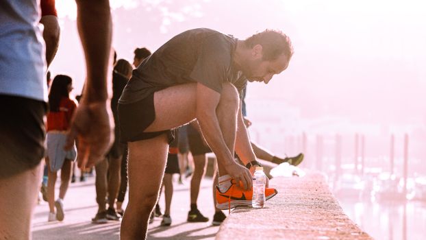 Runner drinking water after a morning run