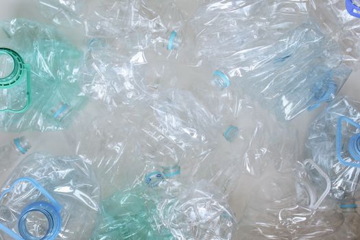 Pile of empty plastic water bottles in a recycling bin