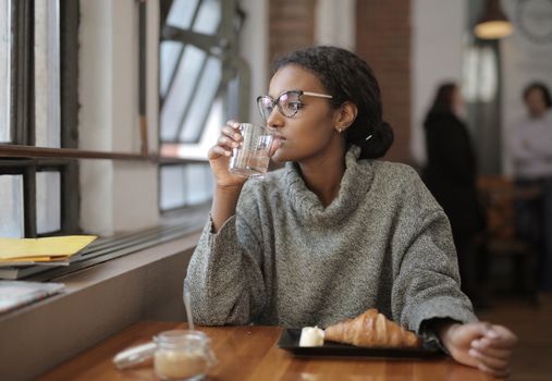 Person drinking water with breakfast in the morning