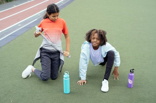 Kid grabbing a water bottle before leaving for practice