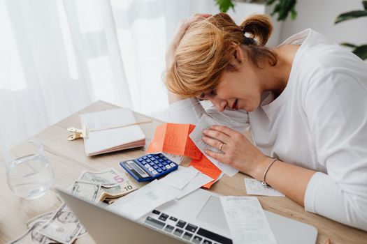Person working out a household budget at a kitchen table