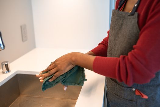 Wiping down a water bottle at the sink