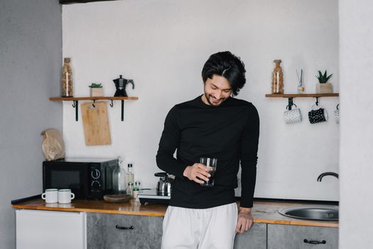 Person holding a hydrogen water bottle at home
