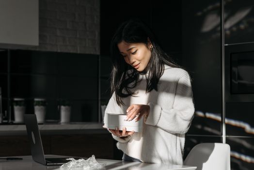 Person unboxing a package on a kitchen table