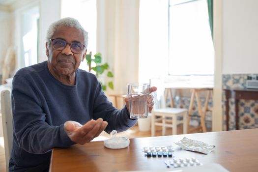 Close-up of hands holding a glass of water