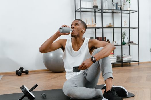 Person drinking water from a bottle while relaxing at home