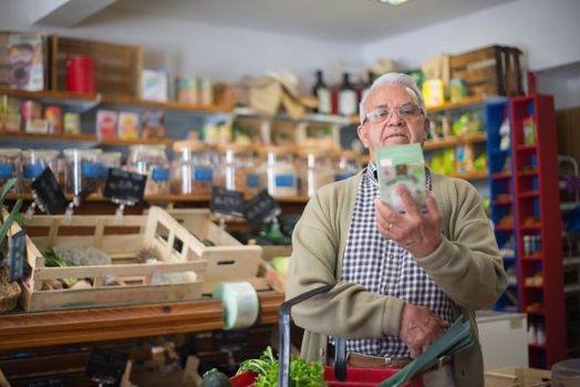 Person reading a food safety label in a grocery store