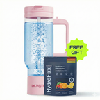 Soft-pink HydroTumbler 32oz on white, the clear chamber filled with rising hydrogen bubbles and DR.WATER wordmark on the pink base, paired with a HydroFixx Hydrogen + Electrolytes pouch (citrus and berry art, 250mg sodium, 500mg potassium, 100mg magnesium) and a green starburst FREE GIFT badge.