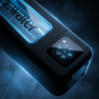 Angled macro of the Hydrator Max held diagonally against a smoky black background, glowing blue water window with bubbles and a lit touchscreen showing its control icons.