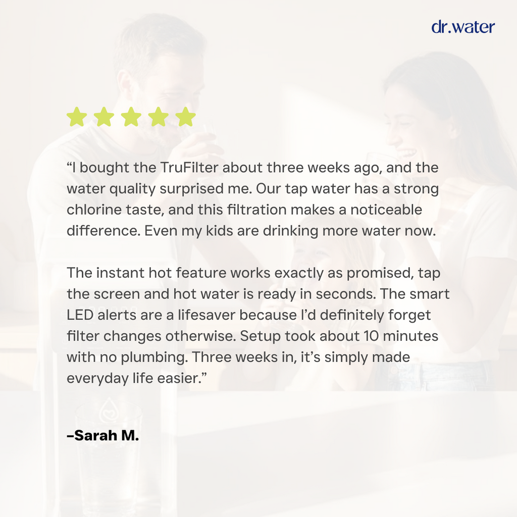 Dr.Water TruFilter customer review card on a dim photo background with five gold stars and dr.water wordmark, featuring Sarah M.'s testimonial about reduced chlorine taste, instant hot water, smart LED filter alerts and a 10-minute setup with no plumbing.