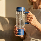 Woman holding HydroTumbler 32oz hydrogen water bottle – lifestyle shot