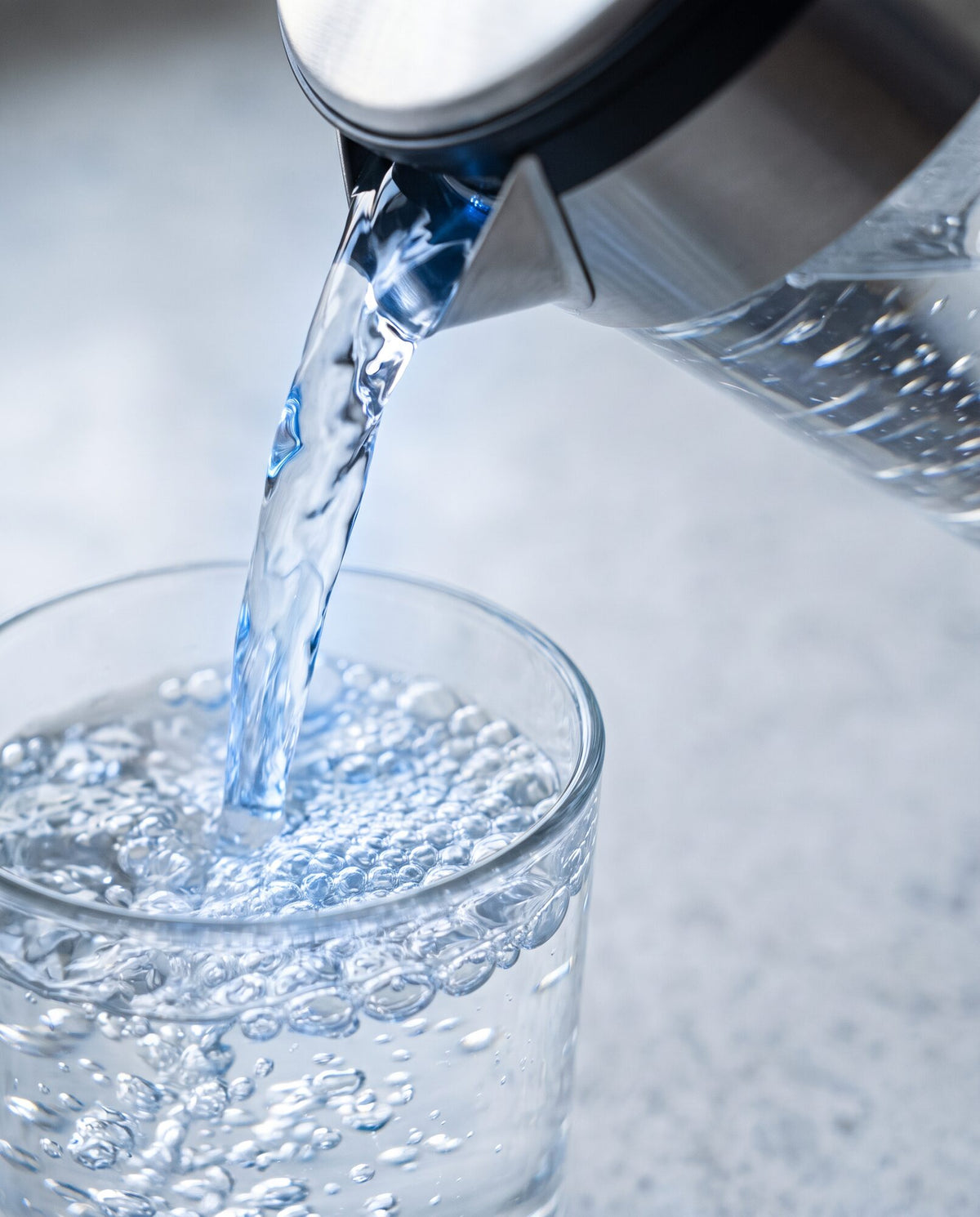 Hydrogen-rich water pouring into a glass, bubbles rising